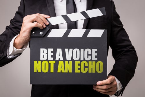 "Be a voice, not an echo," person in suit, cut off under head, holding clapperboard