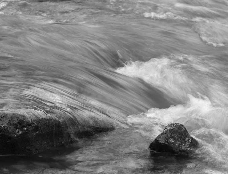 a black and white image of flowing water