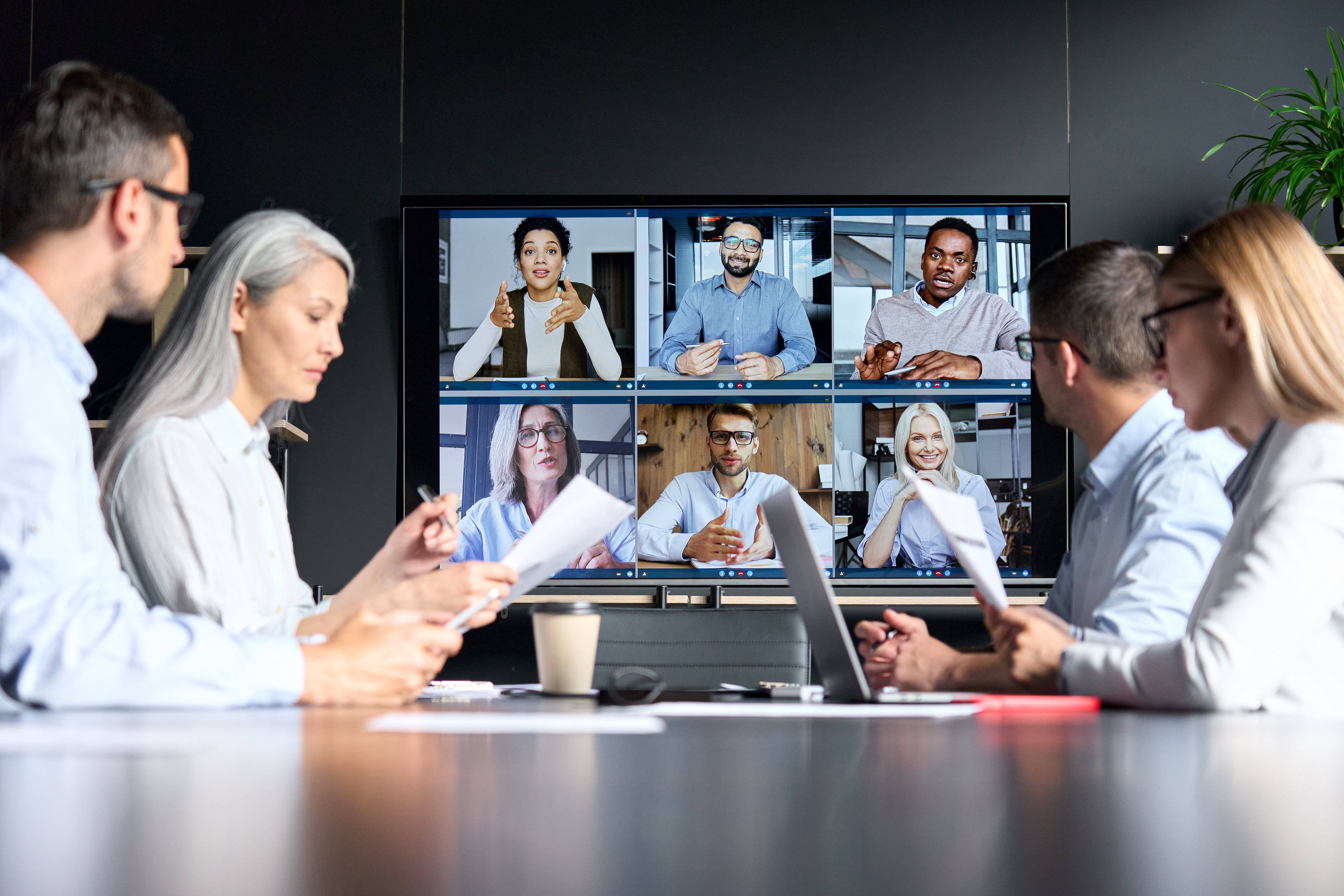 Virtual meeting between colleagues in board room