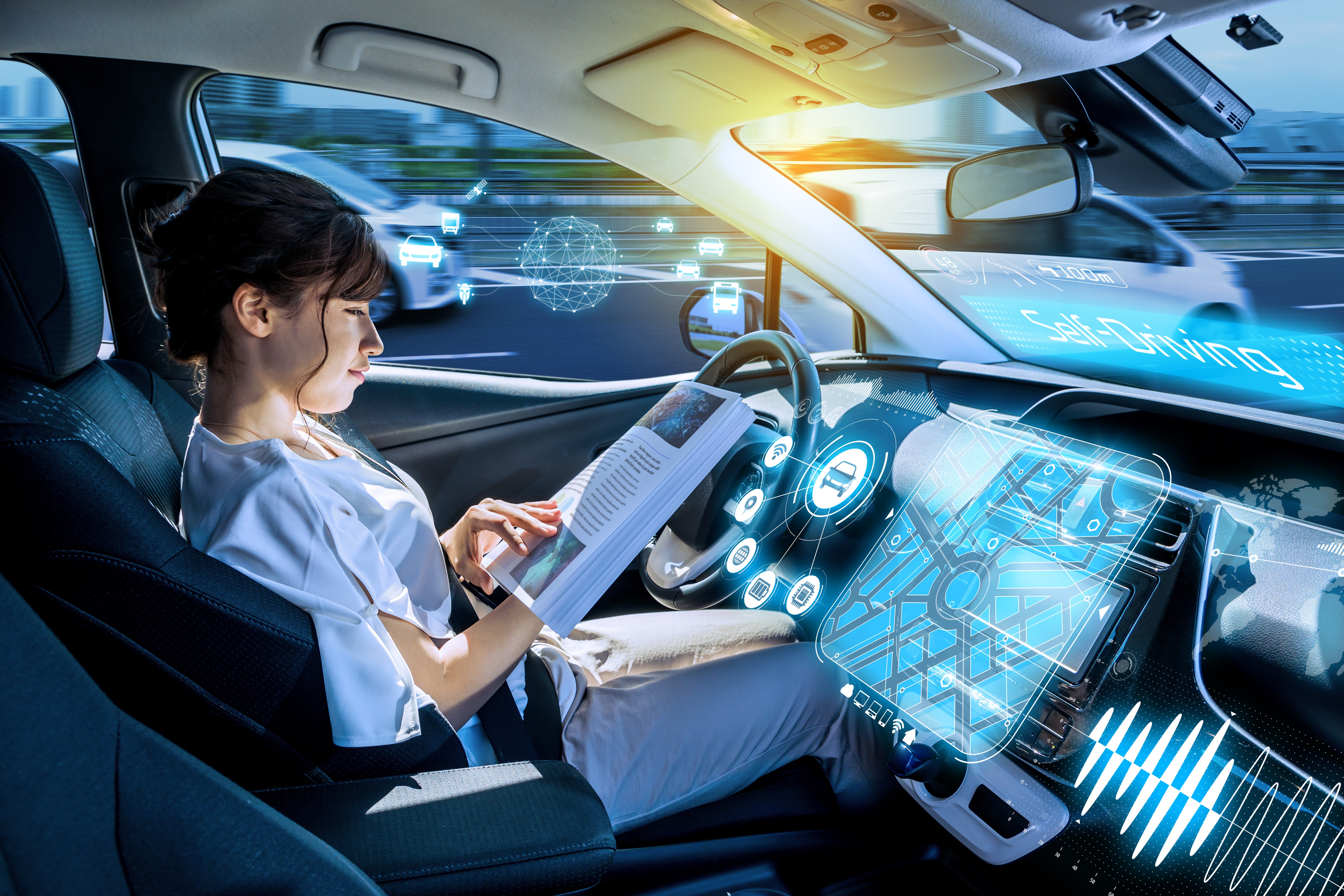 Young woman reading a magazine in a autonomous car.