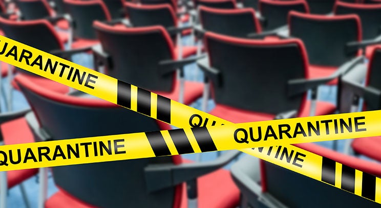 caution tape that reads QUARANTINE marking off rows of chairs