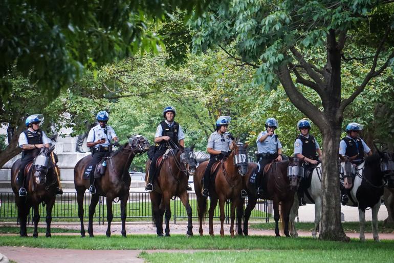 police on horseback in park during Charlottesville, VA, Unite the Right rally, 08/11/17