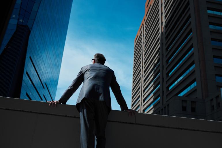 Business leader between buildings