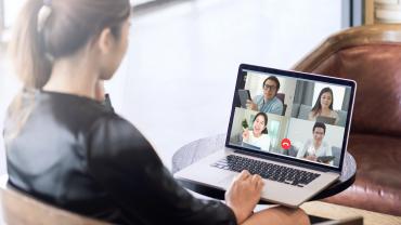 Businesswoman sitting in front of a laptop for a virtual meeting.