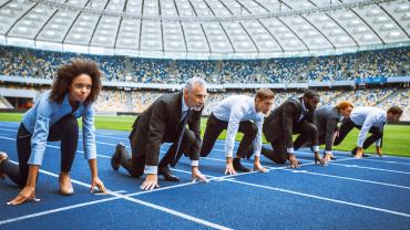 people in business attire at a track starting line