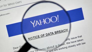 magnifying glass hovers over a document which reads: "Yahoo! Notice of Data Breach"