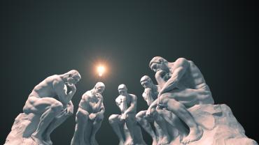 A series of Thinker-like statues with lightbulb alit above one