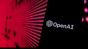OpenAI logo on the background of red lights.