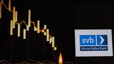 Silicon Valley Bank logo with a declining stock chart in the background. 