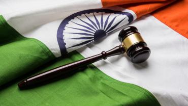 a gavel and the flag of India
