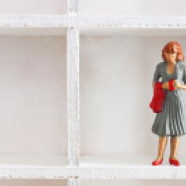 Doll figurine alone on a shelf
