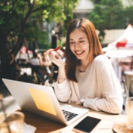 Woman working on her laptop at a cafe