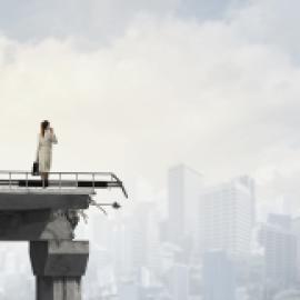 business woman standing on a destroyed bridge