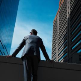 Business leader between buildings