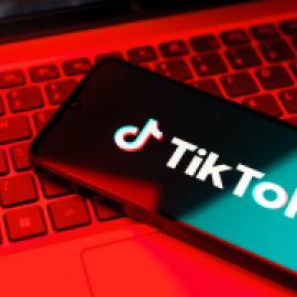 Image of TikTok on a phone with red background