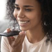 woman smiling and holding phone