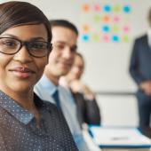 a woman in professional attire smiling at the camera