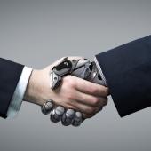 artificial intelligence: a human hand shaking a robot hand