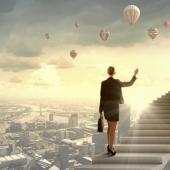 woman holding a briefcase walking up floating stairs above a city landscape