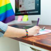 Pride flag and bracelet at work